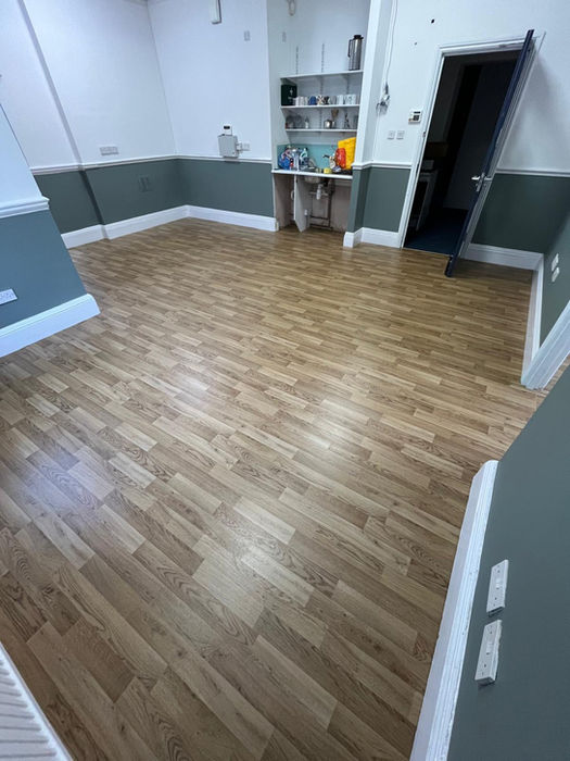 Room with light brown hardwood flooring, empty, ready for new use.