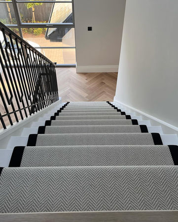 Staircase with carpet and railing in a modern home interior design