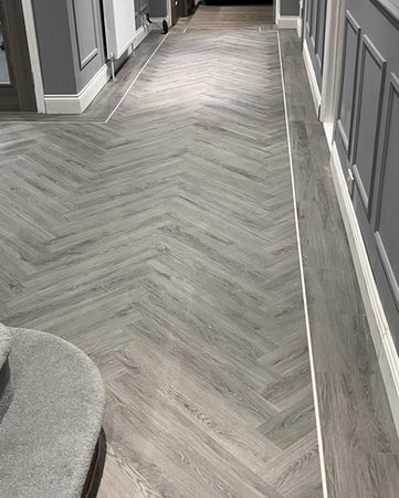 Herringbone pattern flooring in a hallway Carpets & Flooring Showroom Southampton