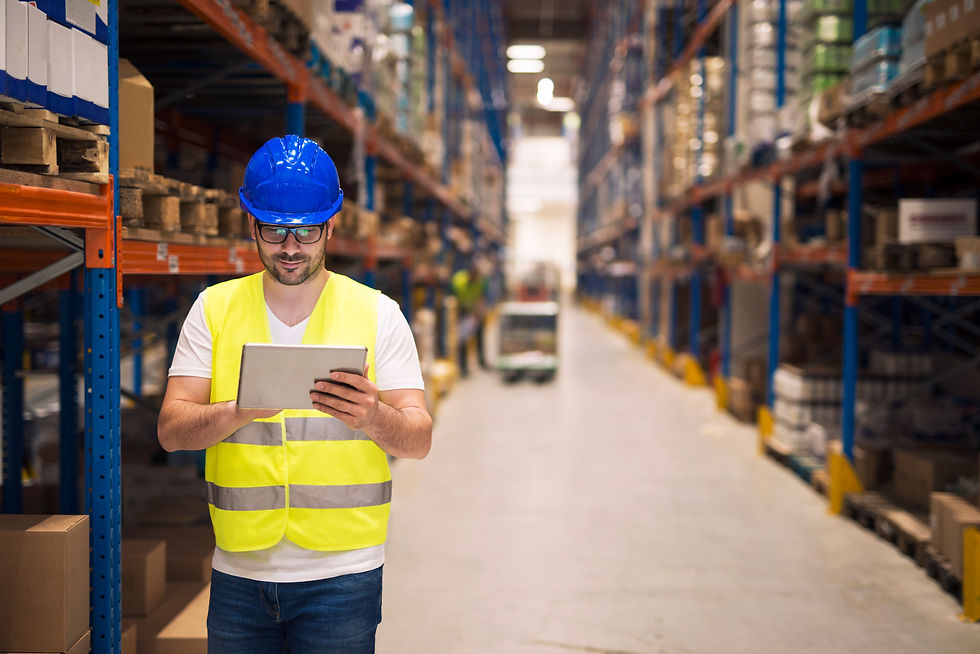 warehouse-worker-checking-inventory-his-tablet-while-walking-large-storage-department-with