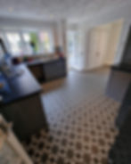 Kitchen with patterned Vinyl Flooring and dark cabinets and counters