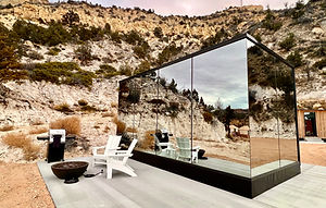 A mirror house agaist a rocky mountainside at East Zion Resort in Orderville, UT.
