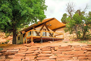 Canvas Cabins at Cave Lakes, Utah with wooden deck and canvas roof built into the red rock hillside.