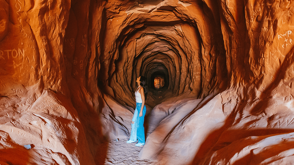 Woman admiring the tunnel walls inside the Belly of the Dragon in Southern Utah
