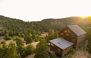 A rustic log cabin called "the lodge" for large family rentals at East Zion Resort.