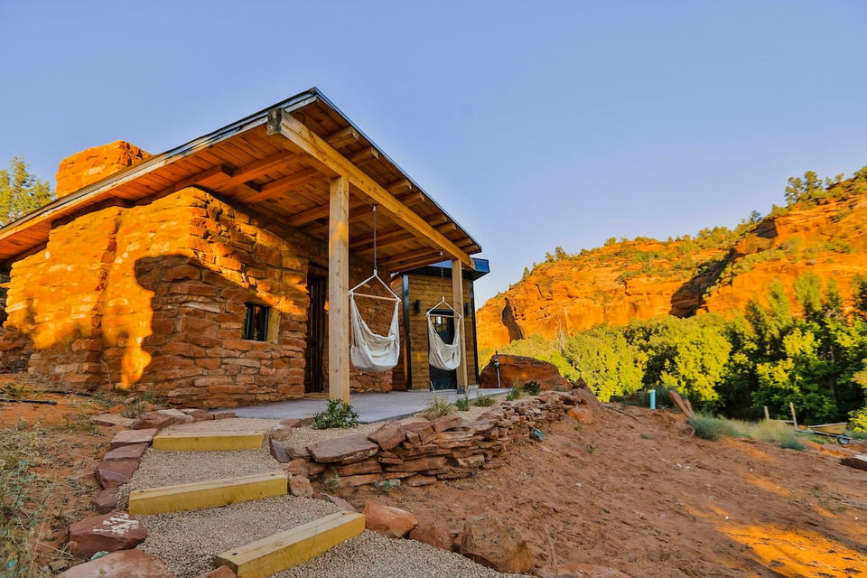 Stone House exterior with covered porch and canyon backdrop.