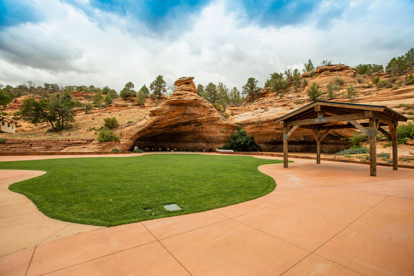 Open outdoor space and pavilion at Cave Lakes with red rock views.