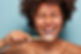 cropped-shot-of-cheerful-glad-dark-skinned-lady-shows-white-teeth-has-overjoyed-expression