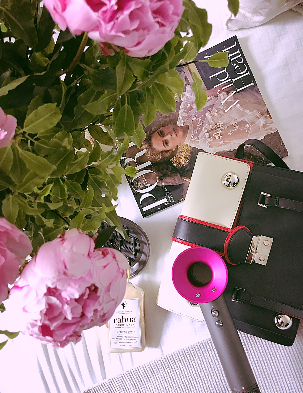 image of flowers a hand bag and Dyson blow dryer