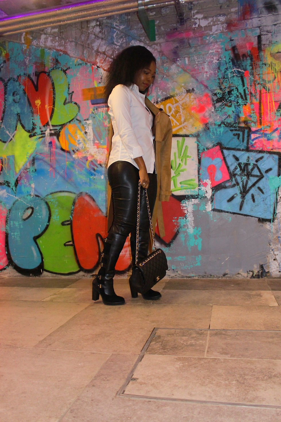 lady standing against graft art