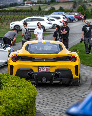 Yellow sports car, rear view, at an automotive event