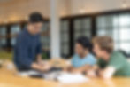 serious-teacher-checking-assignment-two-students.jpg