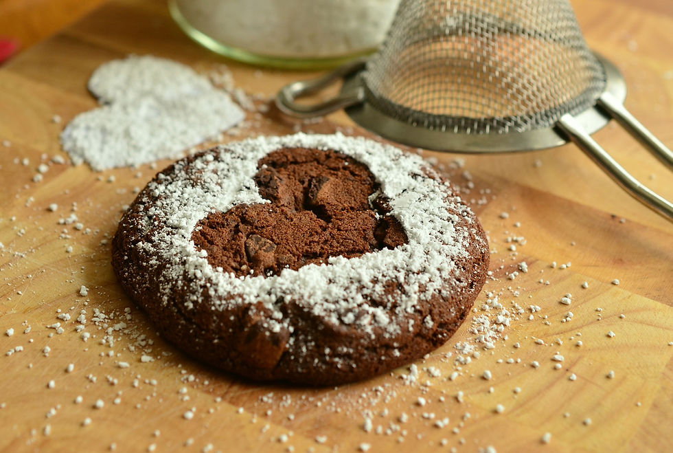 Beautiful chocolate cookie with a heart trimmed in white sprinkles