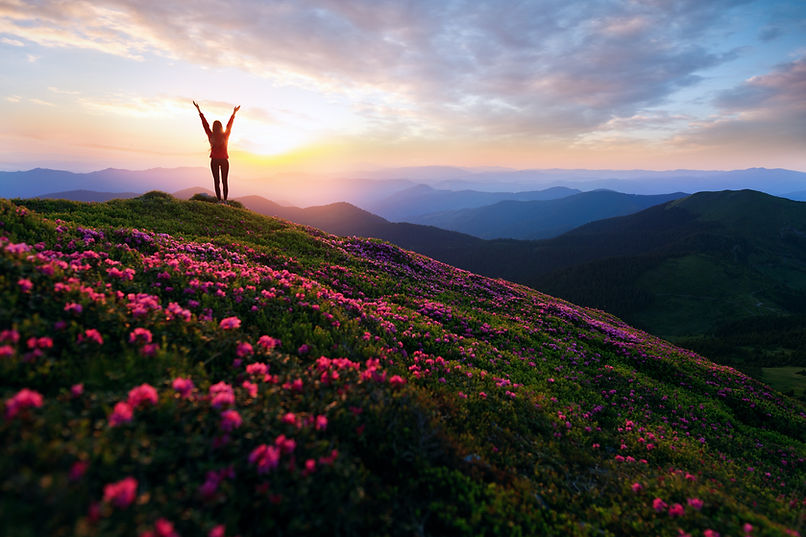 Hiker woman standing with hands up achie