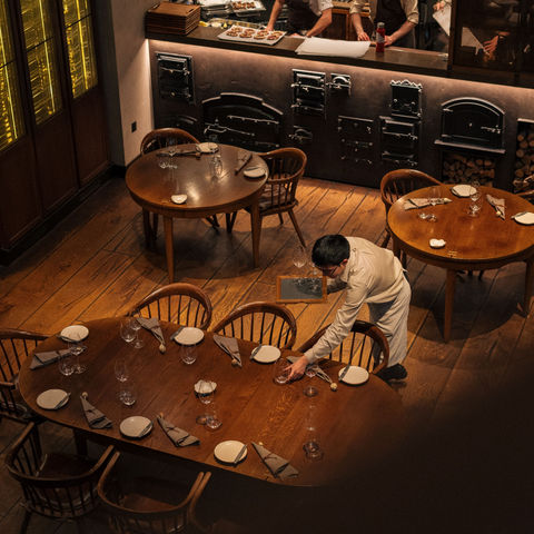 Chef and waitstaff preparing an elegant restaurant for service, showing a repeatable hospitality operating environment
