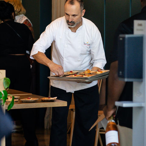 A waiter bringing plates to a restaurant table