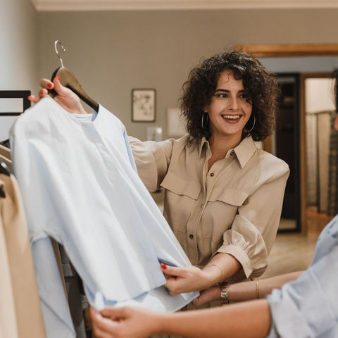 Two women considering a garment in a clothing store