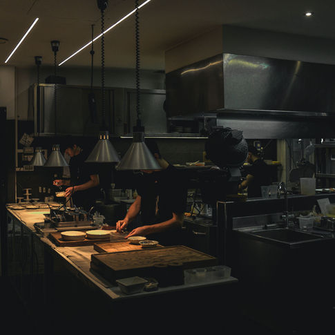 Hospitality team working together in a professional restaurant kitchen