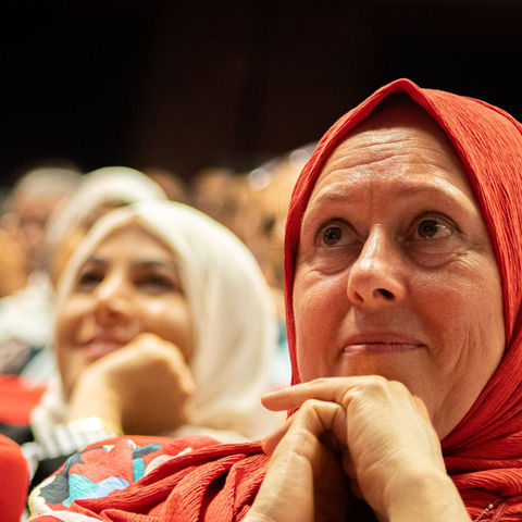 Audience members paying close attention at an indoor cultural event; illustrative stock photograph