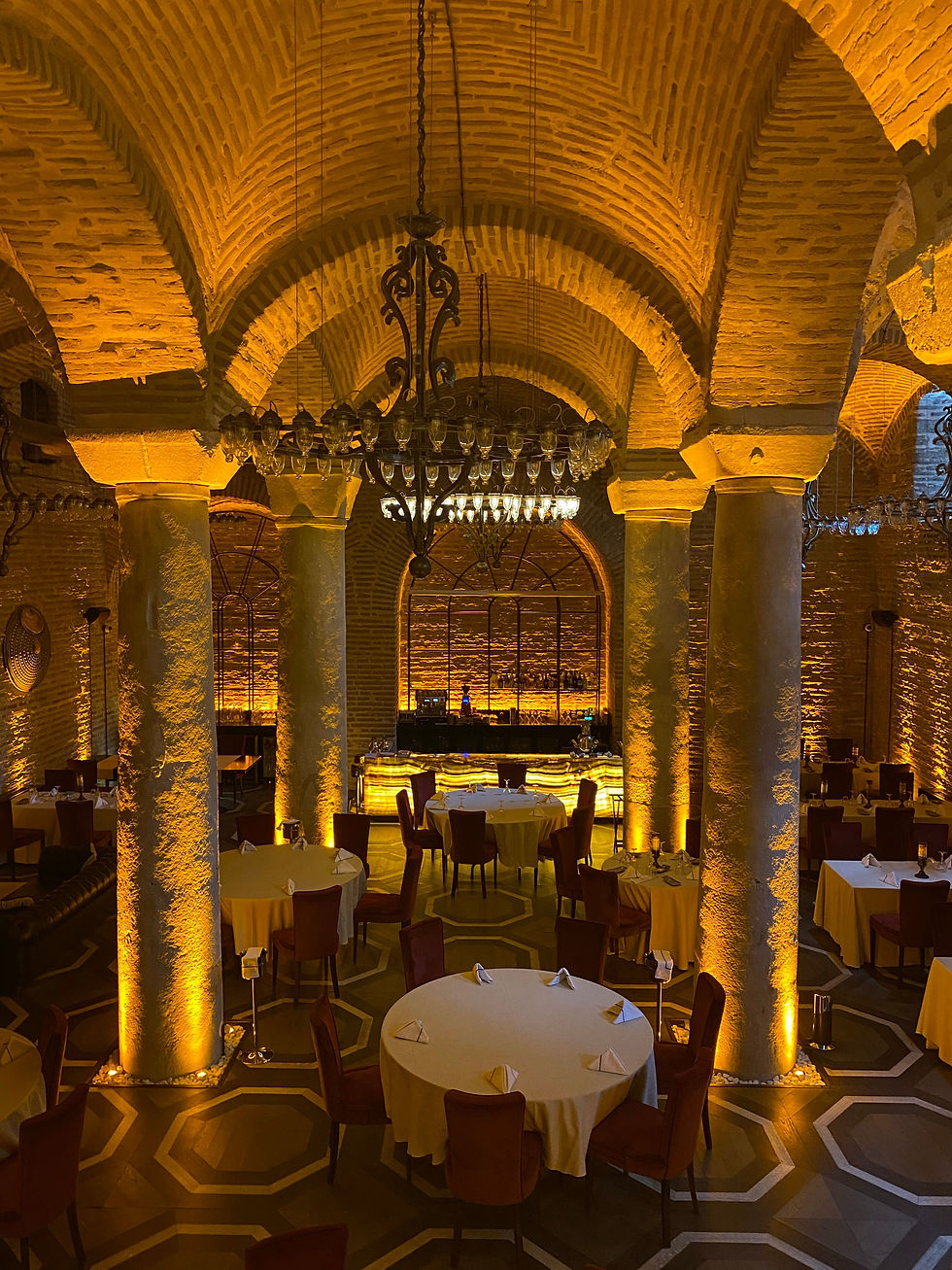 Elegant premium restaurant interior with formal table settings and warm architectural lighting