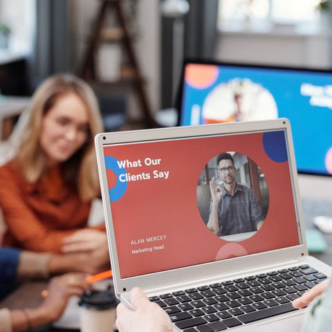 Business team reviewing customer feedback and market information on a laptop during a strategy meeting