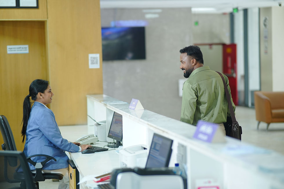 Hotel receptionist assisting a guest at a modern reception desk