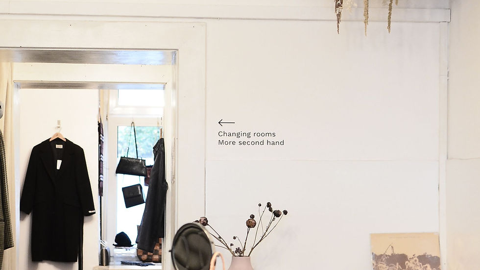 Bright boutique interior with a changing-room sign