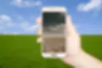 A person holding a cell phone in their hand