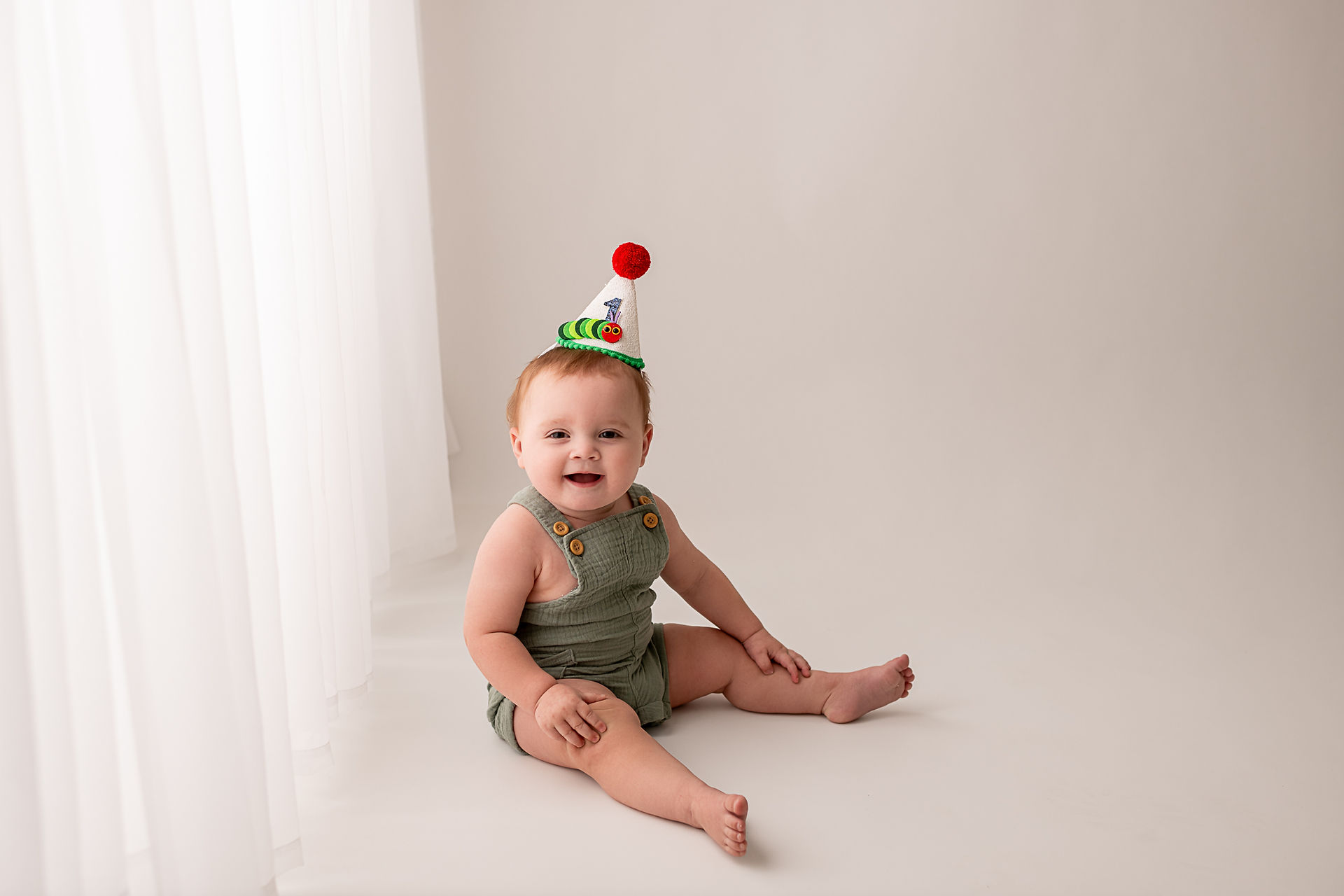 baby boy smiles for first birthfday portraits