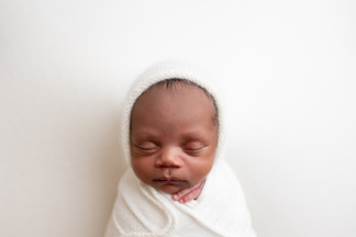 Close up image of newborn boy wrapped in white. Newborn photography in Wilmington, DE.