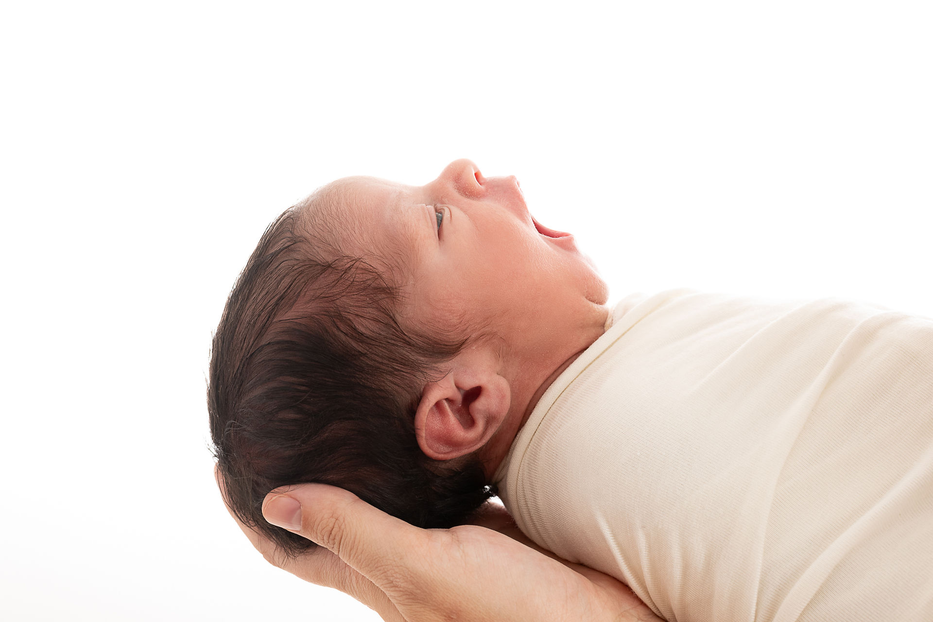 Newborn yawns during photoshoot in Wilmington, Delaware photo studio