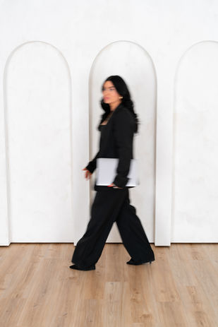 women entrepreneur walking in front of limewashed arch wall in studio in connecticut