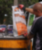 Grantex aggregates being poured into a baron mixer for resin bound surfacing installation on a driveway.