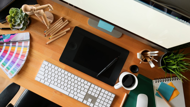 Professional graphic design workspace with branding concepts and design tools