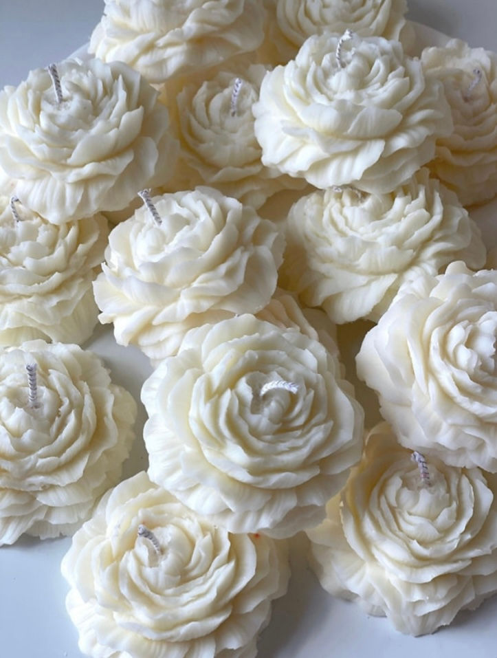 Close-up view of a soy wax candle melting in a glass jar