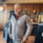Man wearing Black Diamond Men's Belay Parka in color grey. Front view