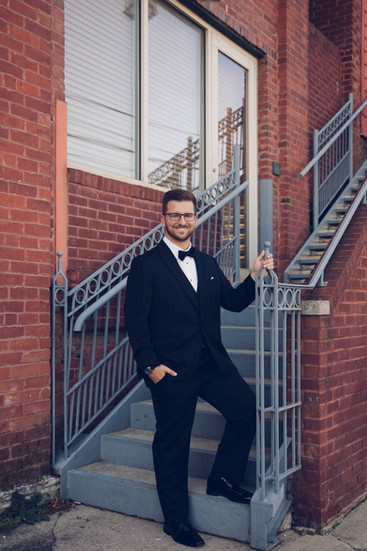 groom on stairs tuxedo