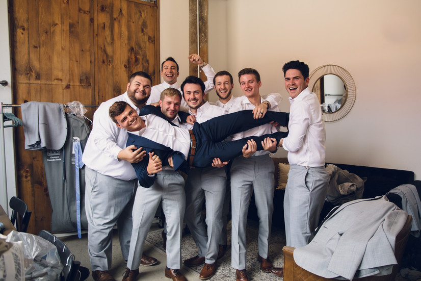 fun groomsmen pose