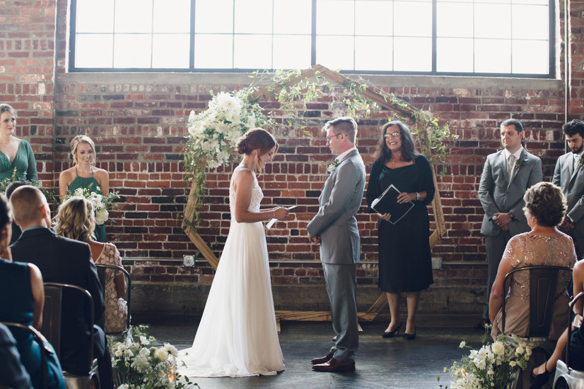 backlit brick wall wedding ceremony