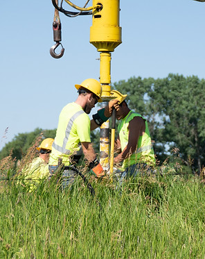 WIPCO line crew drilling hole for new power pole installation