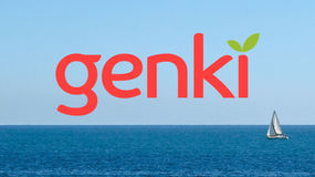 Genki health insurance logo over an ocean background with a sailboat sailing by