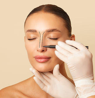 Doctor making marks on female nose, young woman posing on beige studio background with clo