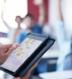 A person holding a tablet