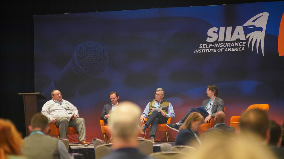 Professionals gather at a Self-Insurance Institute of America (SIIA) conference to hear from experts. Trey Hinson is pictured as a speaker on the panel.