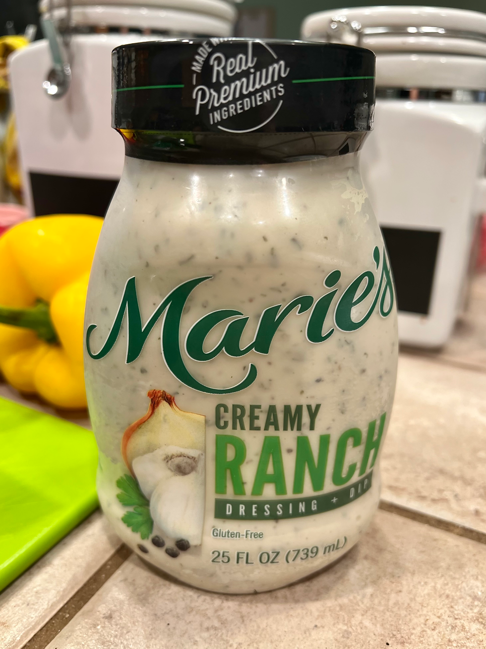 A bottle of Marie's Cream Ranch Dressing placed on a tile counter top.