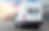 Delivery van driving on road with earn learn drive logo on back doors