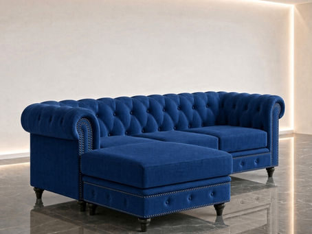 Indian Chesterfield L shape sofa in royal blue fabric with deep button tufting, rolled arms, nailhead trim and a lounger section, on a grey marble floor