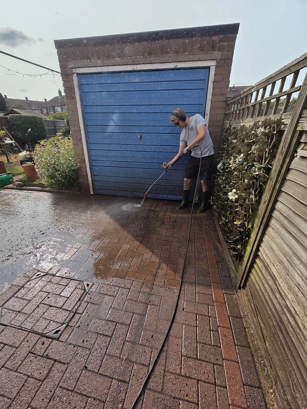 man pressure washing block paving using petrol pressure wahser
