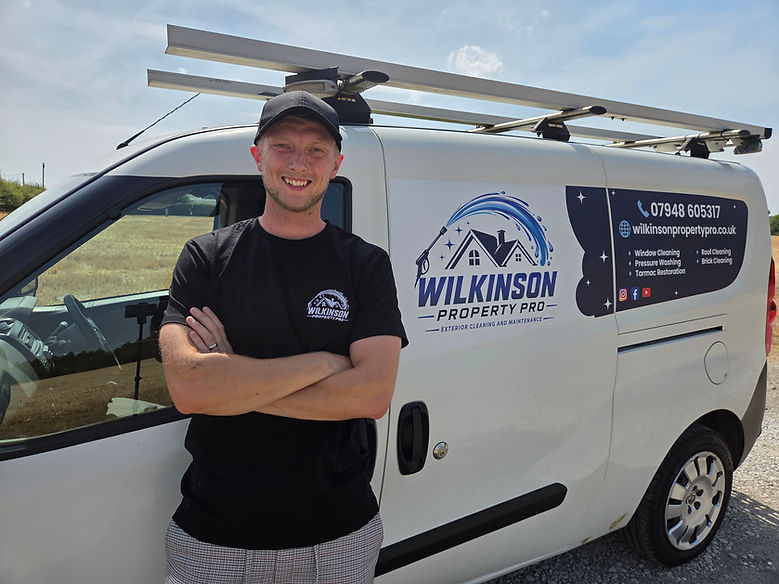owner of wilkinson property pro standing by his van featuring the logo and services