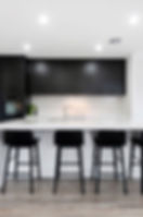monochrome kitchen with black stools